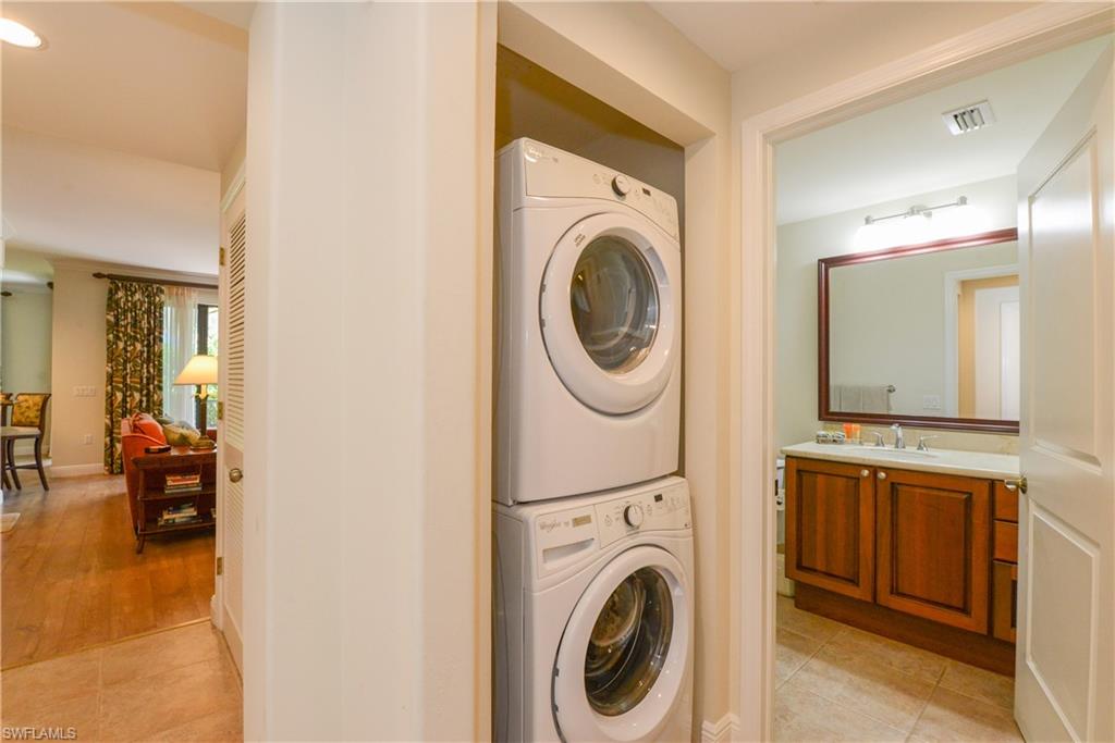 975 Sandpiper Street, Unit A104 Naples, FL 34102 - Photo 16 of 33 a view of a hallway with washer and dryer
