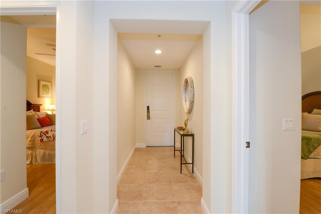 975 Sandpiper Street, Unit A104 Naples, FL 34102 - Photo 17 of 33 a view of a hallway with closet and a couch