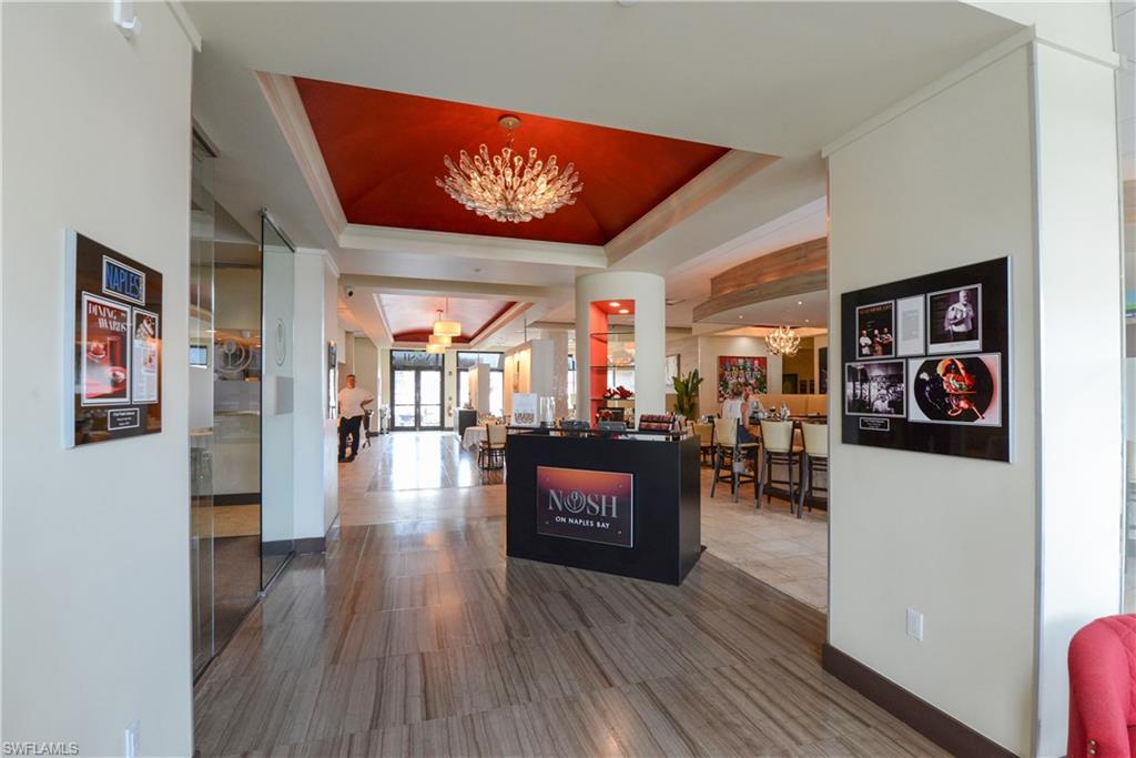 975 Sandpiper Street, Unit A104 Naples, FL 34102 - Photo 33 of 33 a living room with furniture and wooden floor