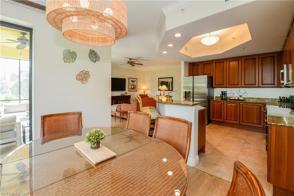 975 Sandpiper Street, Unit A104 Naples, FL 34102 - Photo 10 of 33 a living room with fireplace furniture and a large window