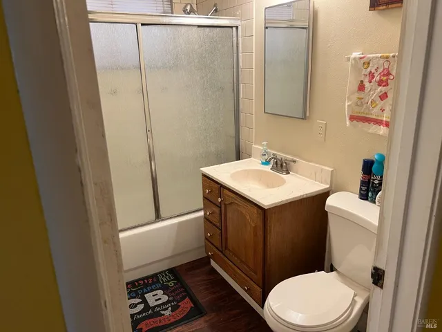a bathroom with a sink a toilet and shower curtain