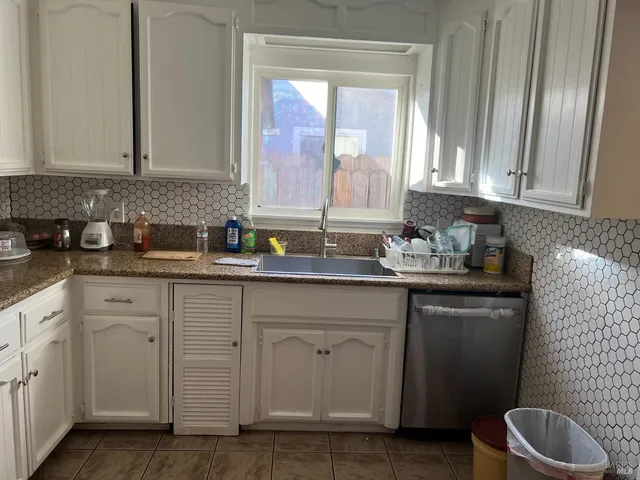 a kitchen with sink cabinets and window