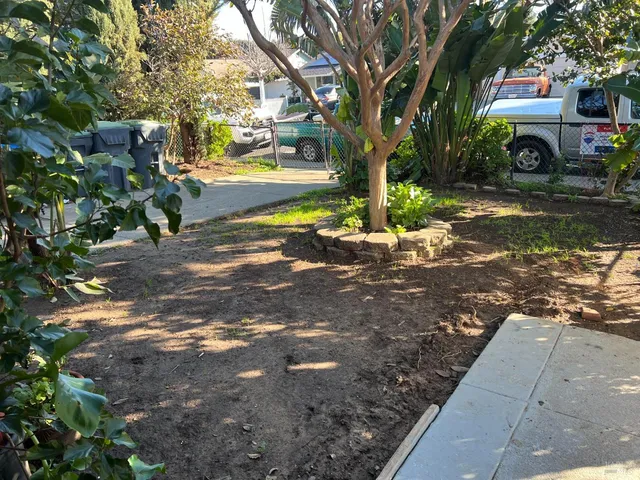 a view of a street with a building and trees in the background