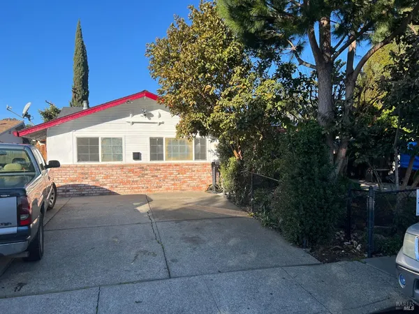 a view of a house with a yard and sitting area