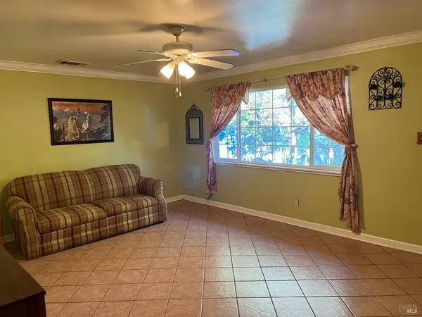 a living room with couches and painting on the wall