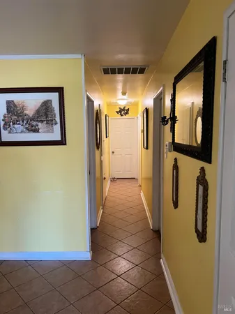 a view of a hallway with wooden shelves