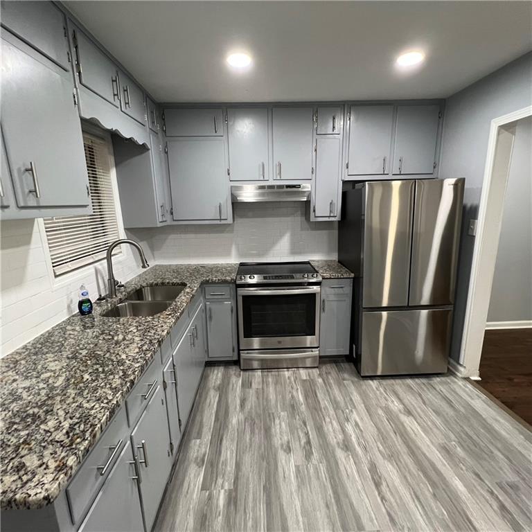 1083 Center Street Southwest, Unit A Mableton, GA 30126 - Photo 11 of 18 a kitchen with a stove a refrigerator and a sink