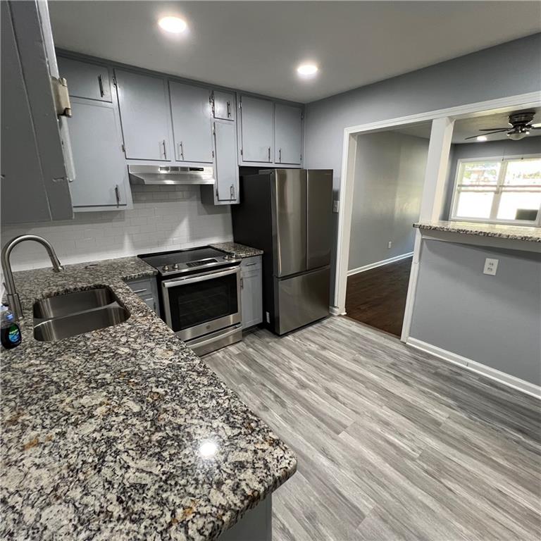 1083 Center Street Southwest, Unit A Mableton, GA 30126 - Photo 13 of 18 a kitchen with granite countertop a refrigerator sink and stove