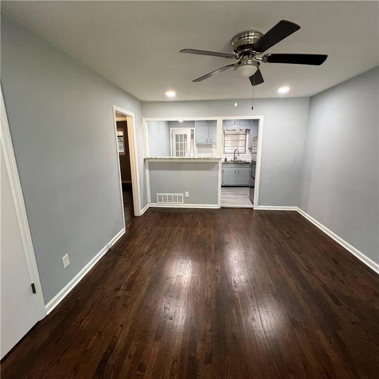 1083 Center Street Southwest, Unit A Mableton, GA 30126 - Photo 6 of 18 a view of a kitchen with wooden floor and a ceiling fan