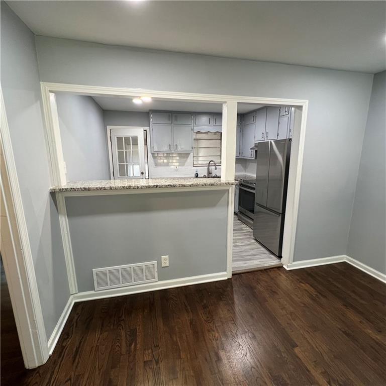 1083 Center Street Southwest, Unit A Mableton, GA 30126 - Photo 7 of 18 a view of a kitchen with wooden floor and electronic appliances