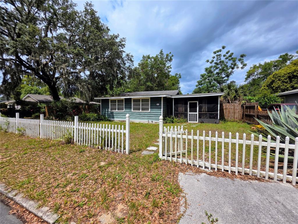 245 South Rhodes Street Mount Dora, FL 32757 - Photo 1 of 1 a front view of a house with a garden