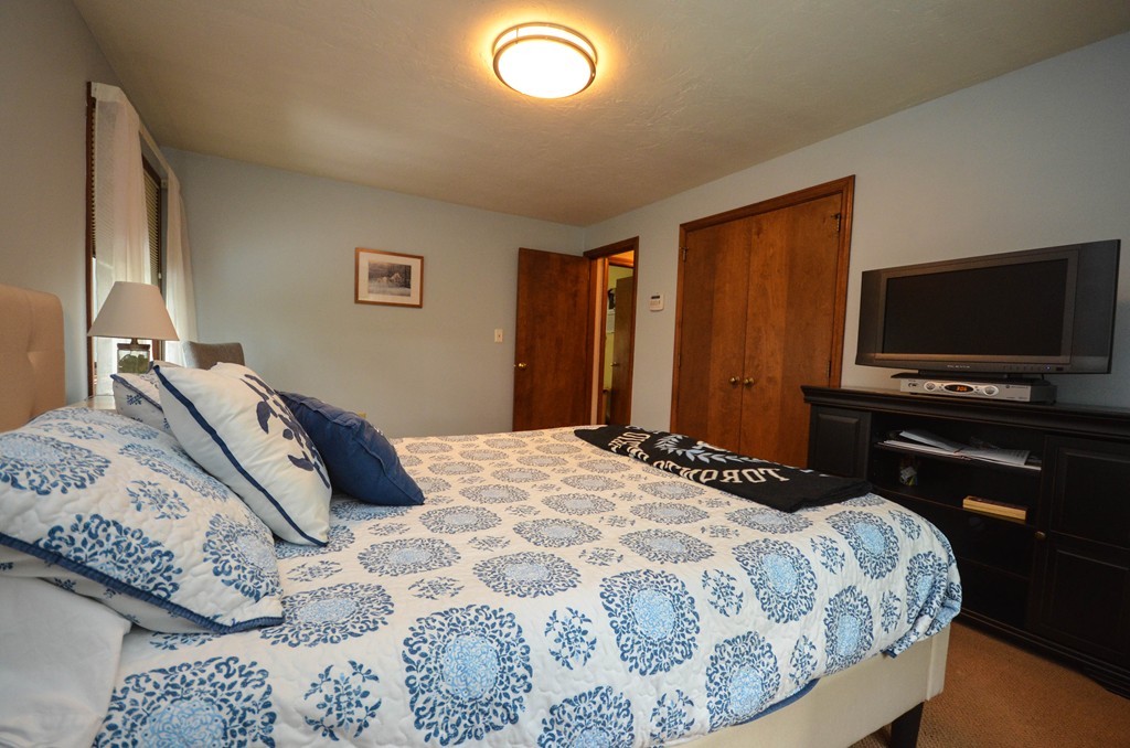 66 Dodge Hill Road Sutton, MA 01590 - Photo 13 of 29 a bedroom with a bed and a flat screen tv