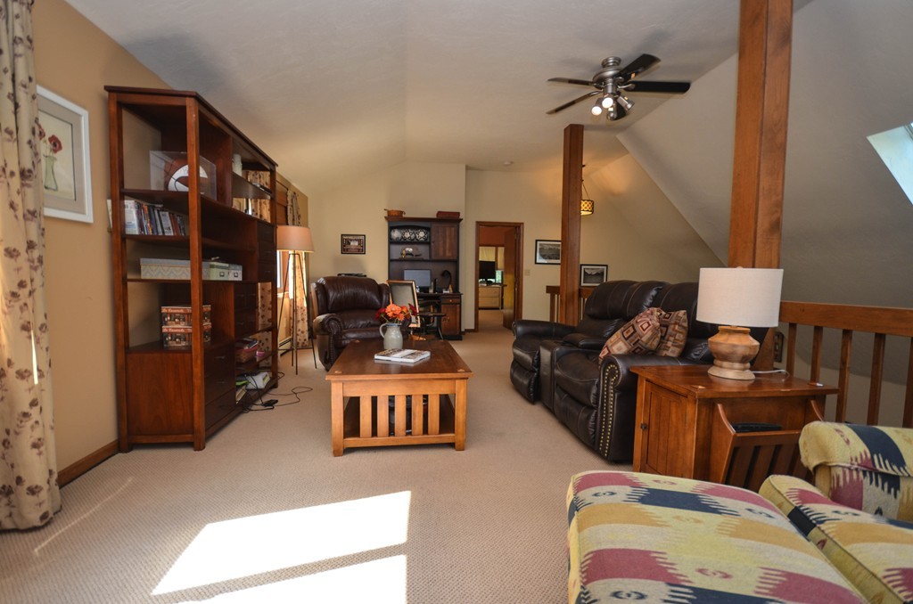 66 Dodge Hill Road Sutton, MA 01590 - Photo 18 of 29 a living room with furniture kitchen view and a chandelier