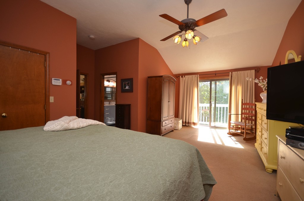 66 Dodge Hill Road Sutton, MA 01590 - Photo 20 of 29 a bedroom with a bed and a flat tv screen on dresser