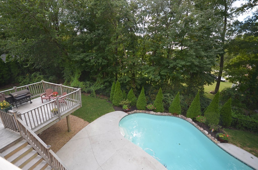 66 Dodge Hill Road Sutton, MA 01590 - Photo 21 of 29 a view of a roof deck with couches and wooden fence