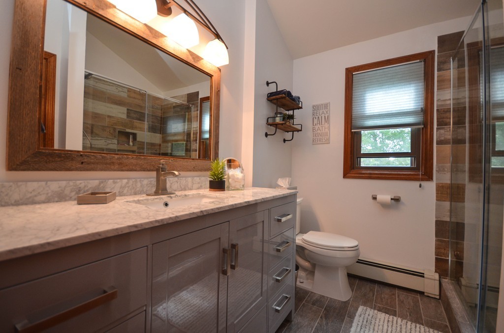66 Dodge Hill Road Sutton, MA 01590 - Photo 22 of 29 a bathroom with a granite countertop toilet sink and mirror