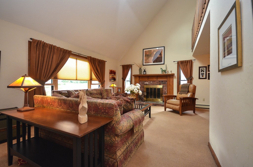 66 Dodge Hill Road Sutton, MA 01590 - Photo 3 of 29 a living room with furniture a fireplace and a large window