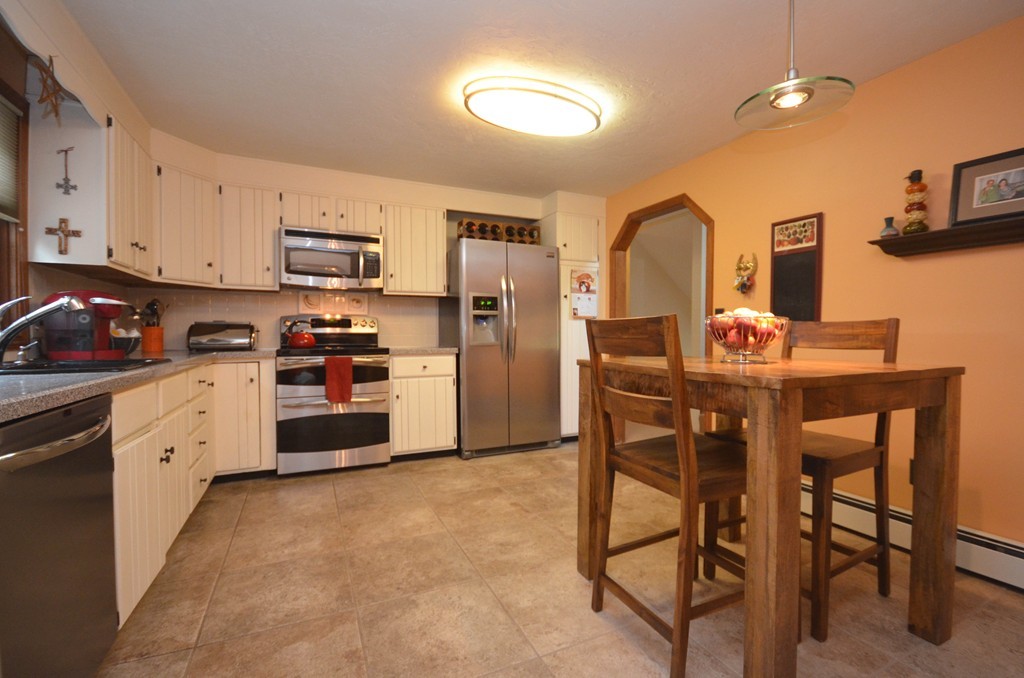 66 Dodge Hill Road Sutton, MA 01590 - Photo 7 of 29 a kitchen with stainless steel appliances granite countertop a stove a sink dishwasher and a refrigerator with wooden floor