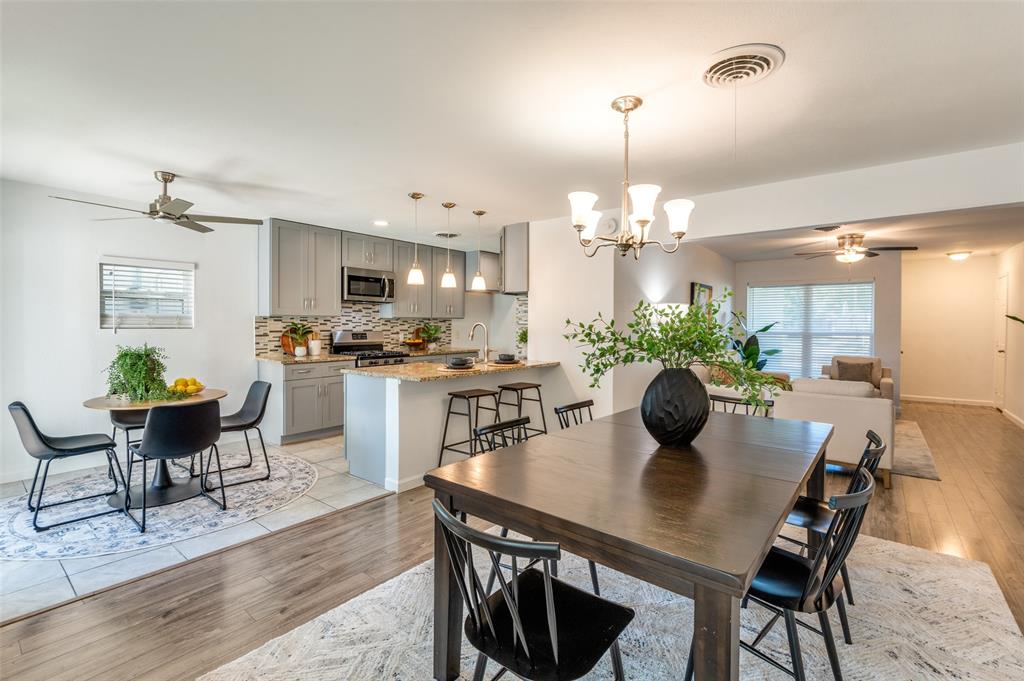 1209 Ridgeway Drive Richardson, TX 75080 - Photo 17 of 33 a view of a dining room and livingroom with furniture wooden floor a chandelier