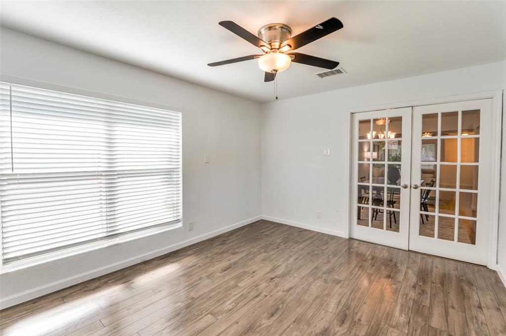 1209 Ridgeway Drive Richardson, TX 75080 - Photo 21 of 33 an empty room with wooden floor and windows