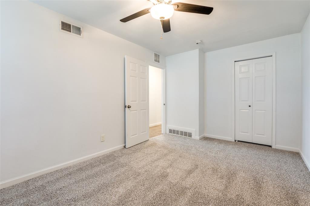 1209 Ridgeway Drive Richardson, TX 75080 - Photo 23 of 33 an empty room with chandelier fan