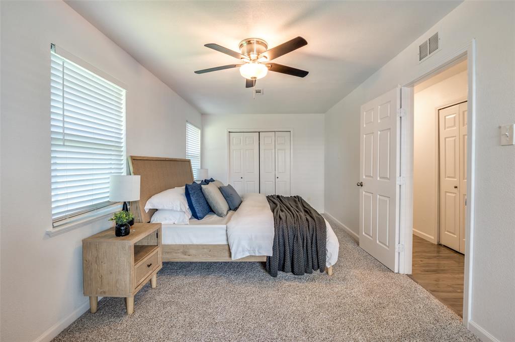 1209 Ridgeway Drive Richardson, TX 75080 - Photo 26 of 33 a bed room with a bed and a chandelier