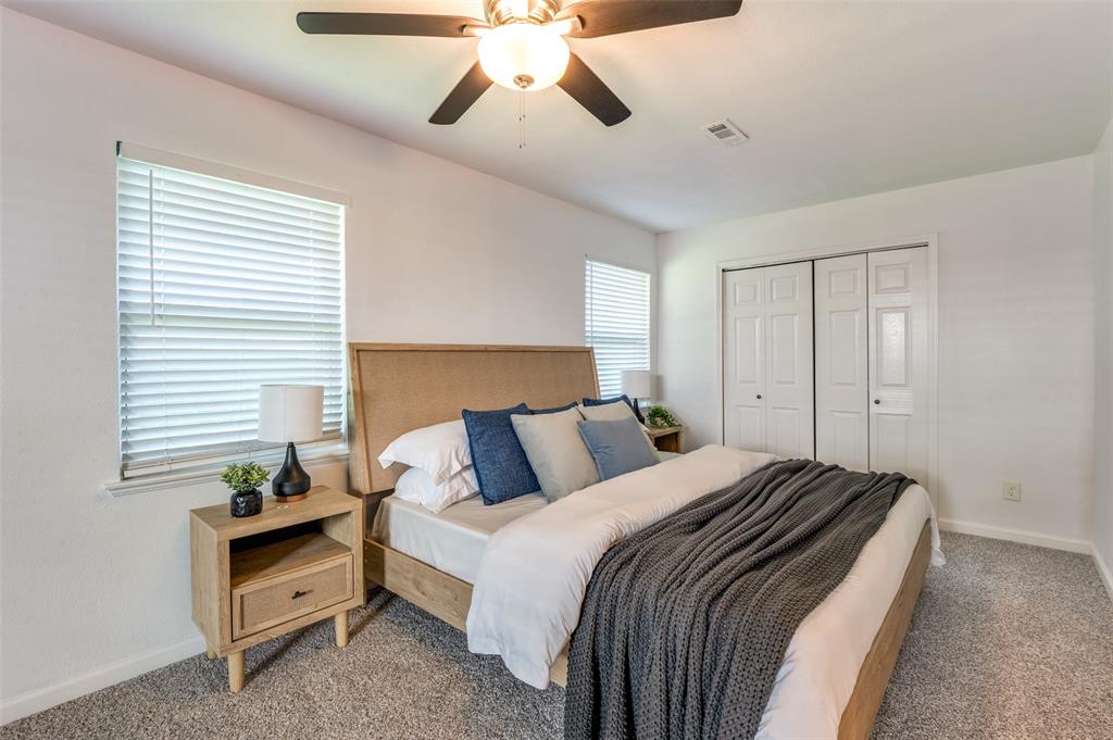 1209 Ridgeway Drive Richardson, TX 75080 - Photo 27 of 33 a bedroom with bed and a chandelier