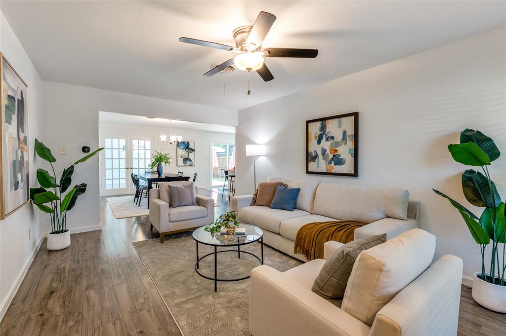 1209 Ridgeway Drive Richardson, TX 75080 - Photo 6 of 33 a living room with furniture and a chandelier