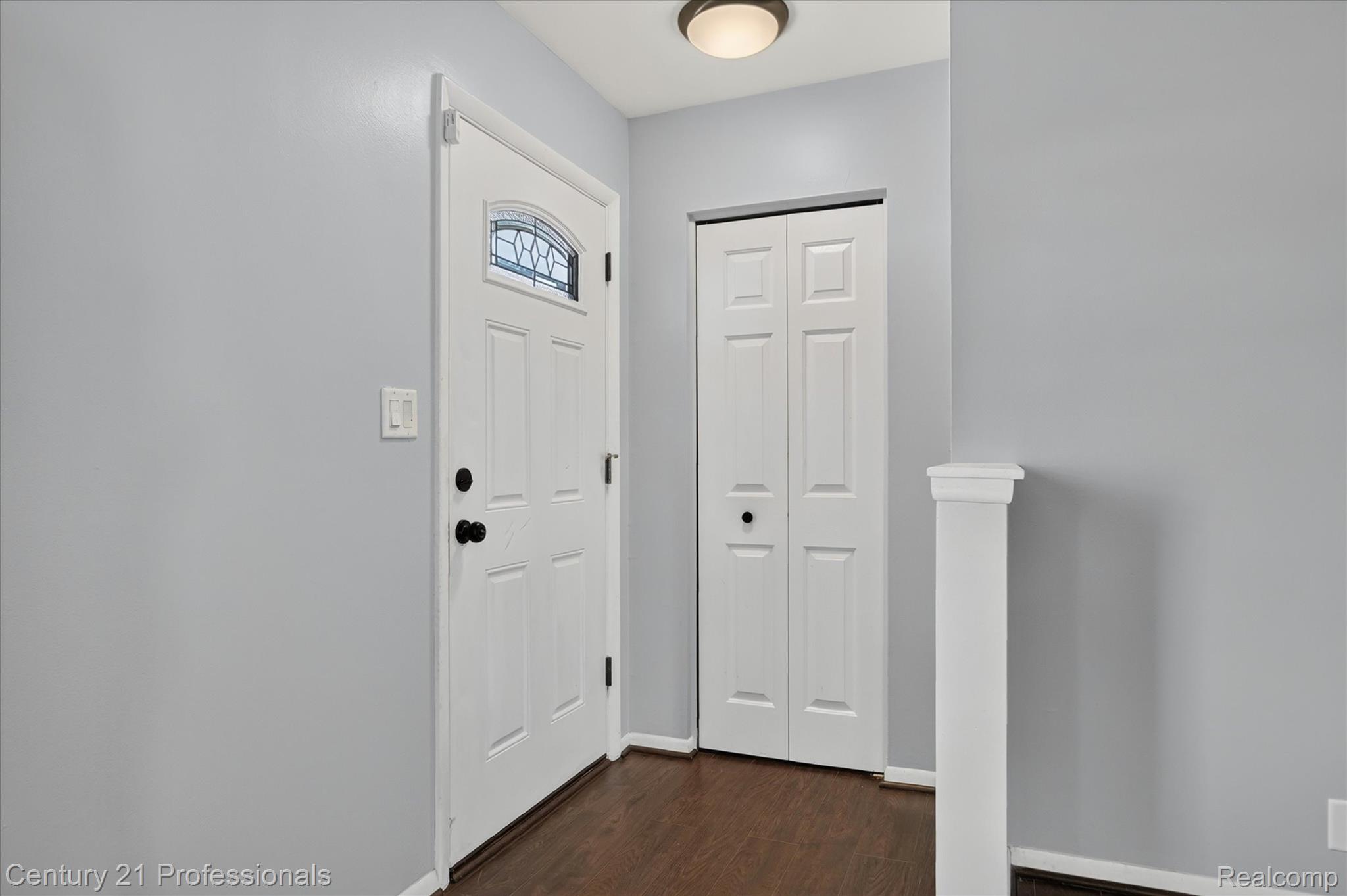 648 Newport Road Carleton, MI 48117 - Photo 8 of 37 Entryway featuring a white paneled door with decorative glass, dark wood-finish flooring, and light gray walls