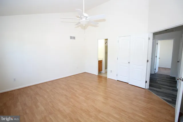 a view of an empty room with wooden floor