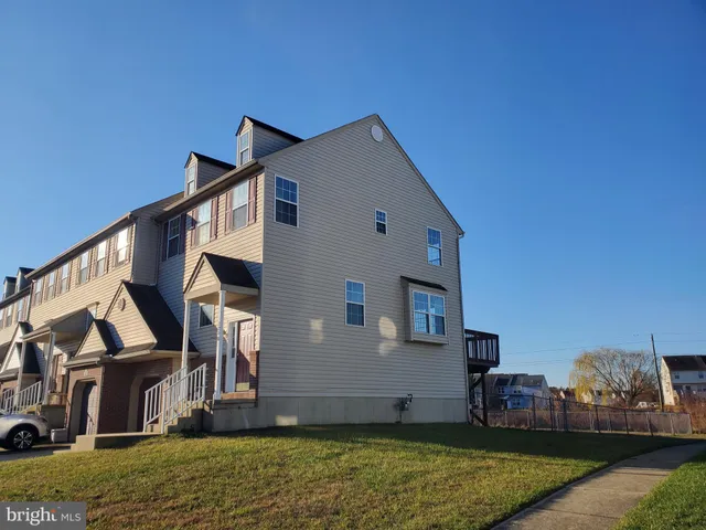 a view of an house with backyard space and balcony