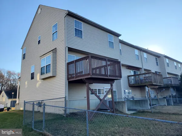 a view of a house with wooden fence