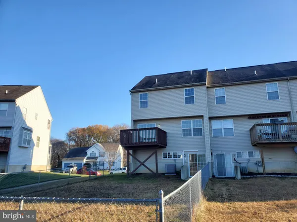 a view of building with car parked