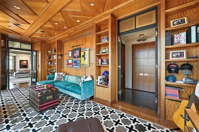 a bedroom with a bed and a flat tv screen on dresser