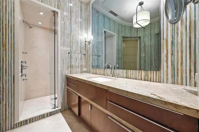 a bedroom with a bed lamp and a fireplace