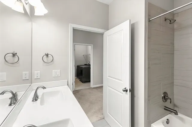 a bathroom with a tub sink and mirror