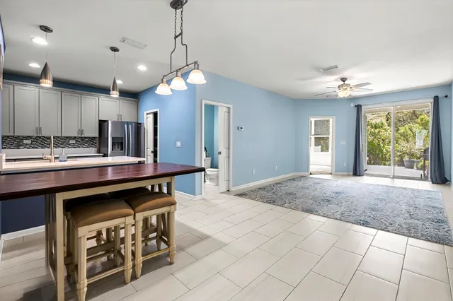a kitchen with kitchen island granite countertop a sink cabinets and window