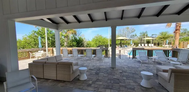 a view of a patio with couches chairs and potted plants