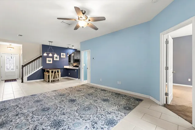 a view of a kitchen with a sink and a refrigerator