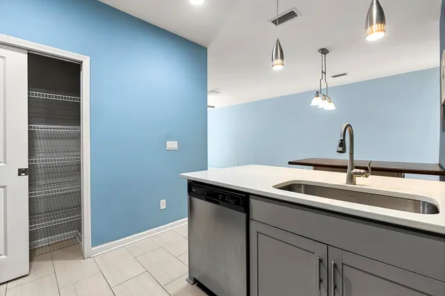 a kitchen with a sink and a mirror