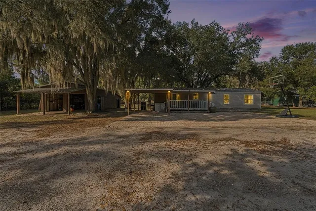 a view of a house with a backyard