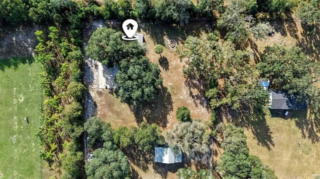an aerial view of a house with a yard
