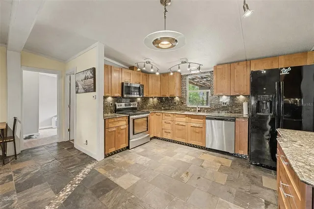 a kitchen with a sink refrigerator and cabinets