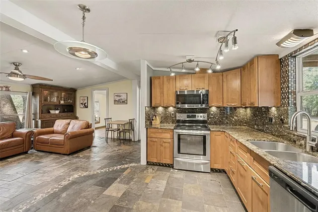 a kitchen with a stove a sink and a refrigerator