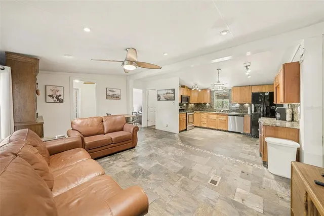 a living room with furniture and kitchen view