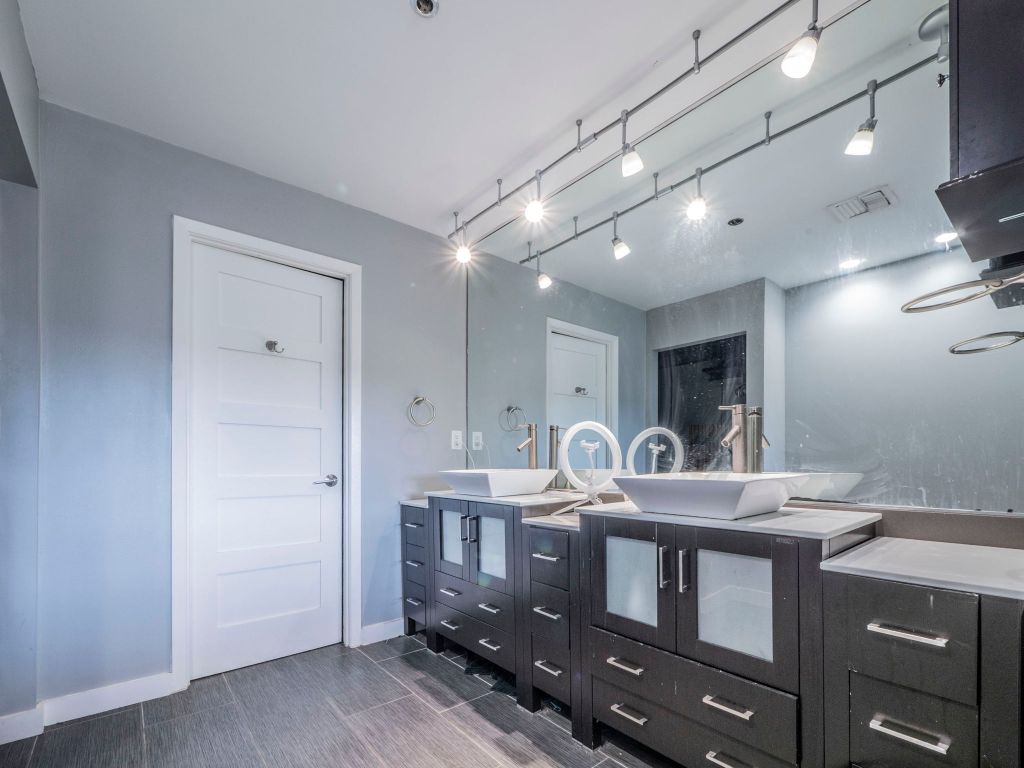 40 North Interstate Highway 35, Unit 4A4 Austin, TX 78701 - Photo 14 of 40 a bathroom with a sink double vanity and a mirror