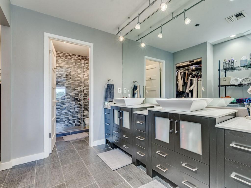 40 North Interstate Highway 35, Unit 4A4 Austin, TX 78701 - Photo 15 of 40 a bathroom with a sink a vanity and a large mirror
