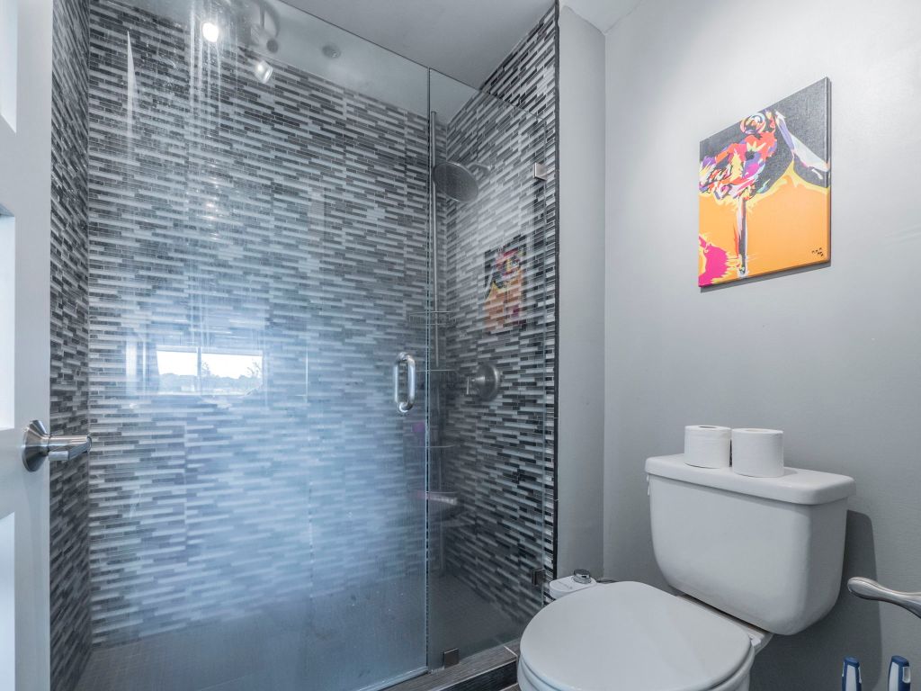 40 North Interstate Highway 35, Unit 4A4 Austin, TX 78701 - Photo 16 of 40 a bathroom with a toilet and a shower curtain