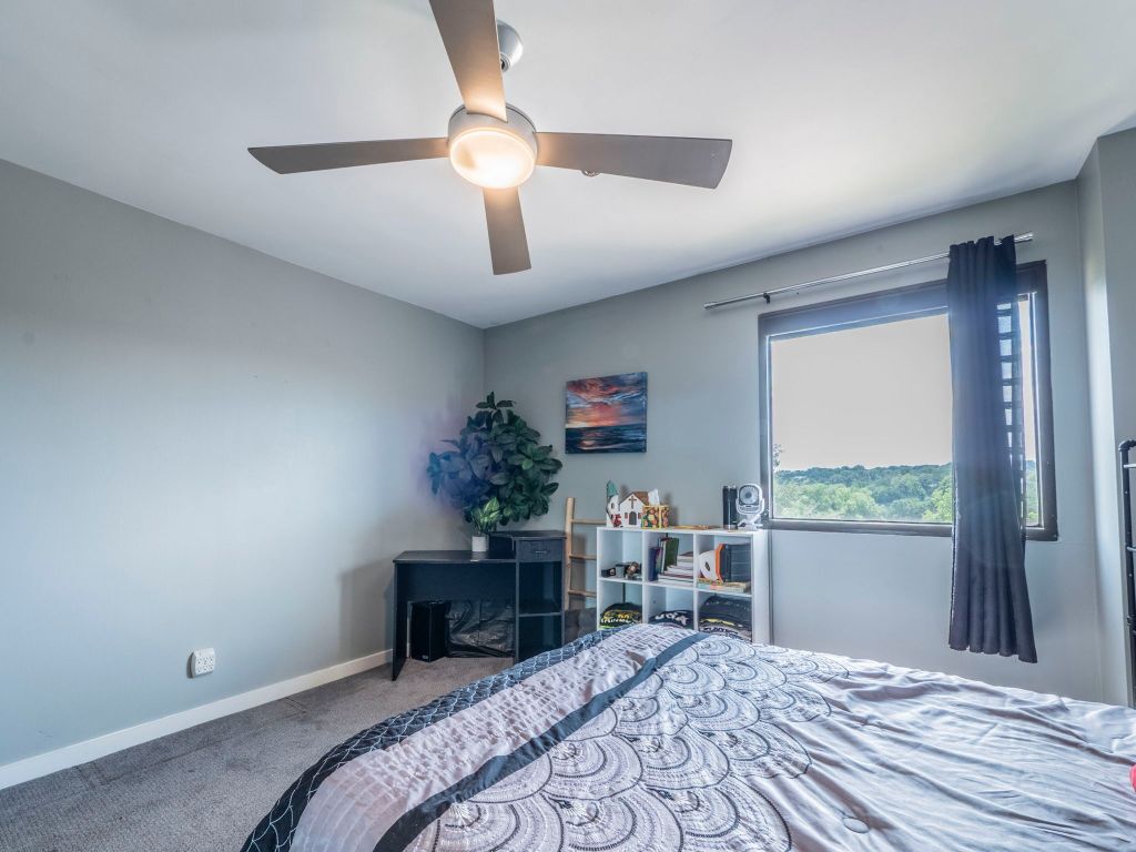 40 North Interstate Highway 35, Unit 4A4 Austin, TX 78701 - Photo 19 of 40 a bedroom with a bed and a potted plant