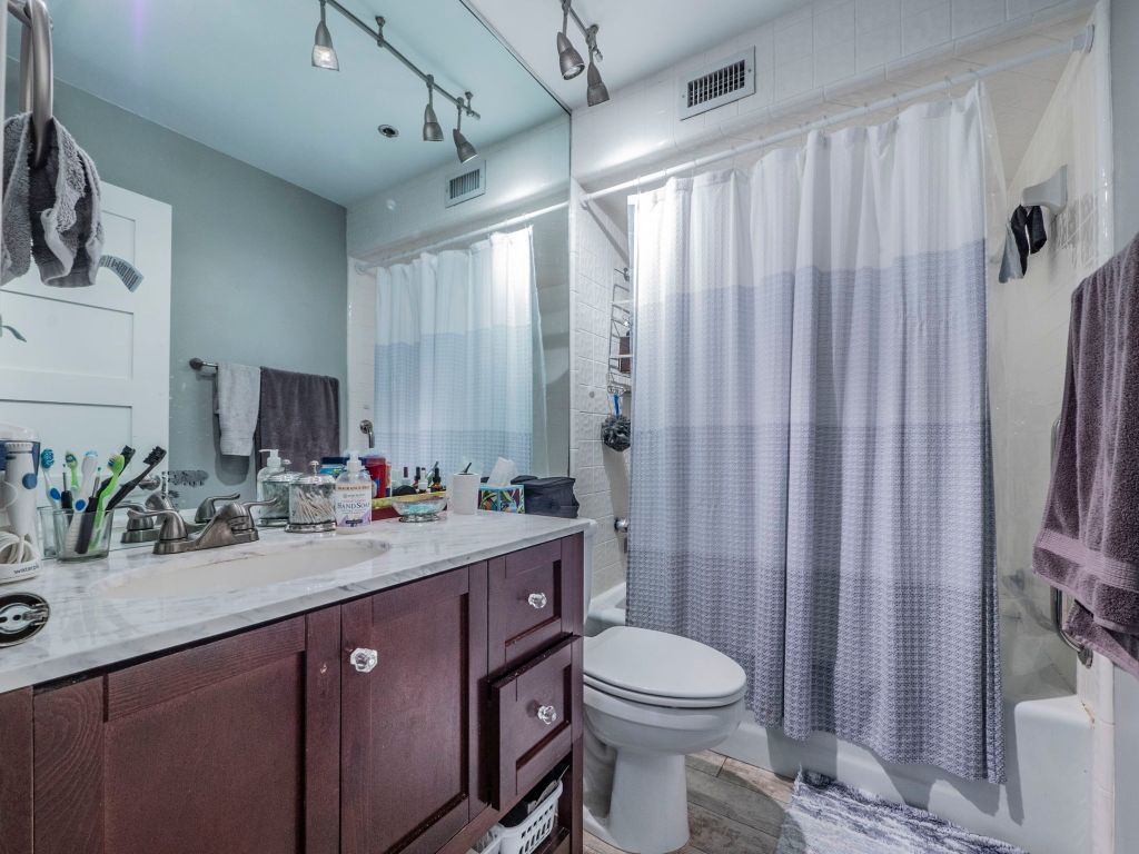 40 North Interstate Highway 35, Unit 4A4 Austin, TX 78701 - Photo 20 of 40 a bathroom with a double vanity sink toilet and shower